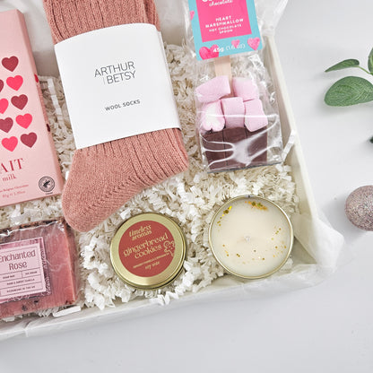 Christmas hamper for her featuring pink Arthur Betsy wool socks, heart chocolate and Cocoba marshmallow hot chocolate spoon