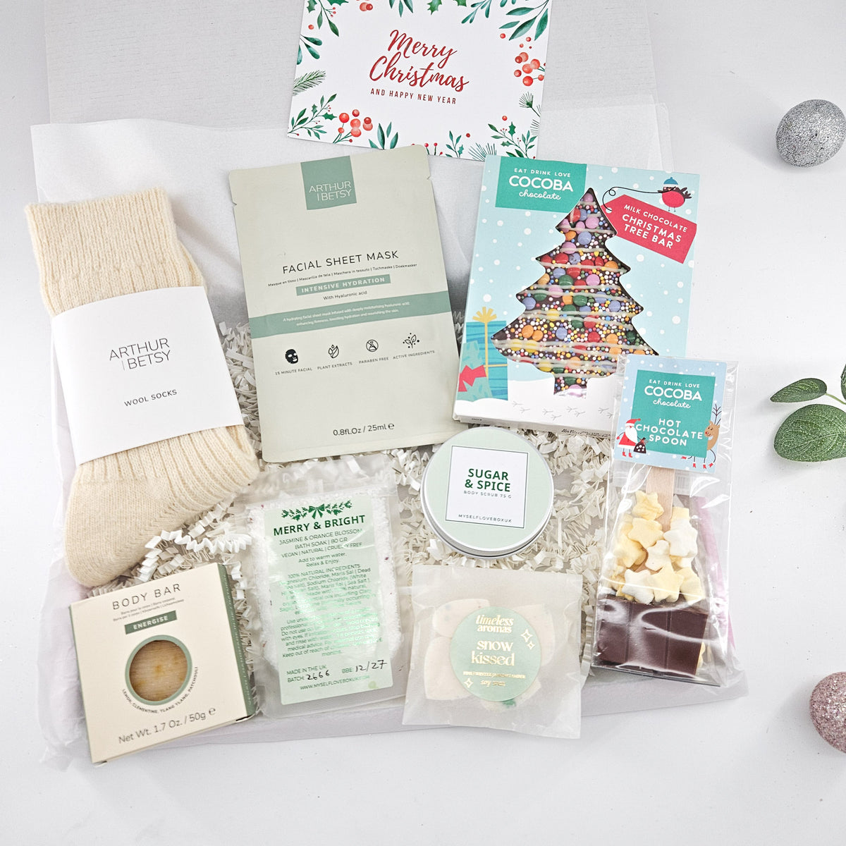 Christmas self-care gift box with cream wool socks, Cocoba chocolate, skincare, bath treats and Snow Kissed wax melts