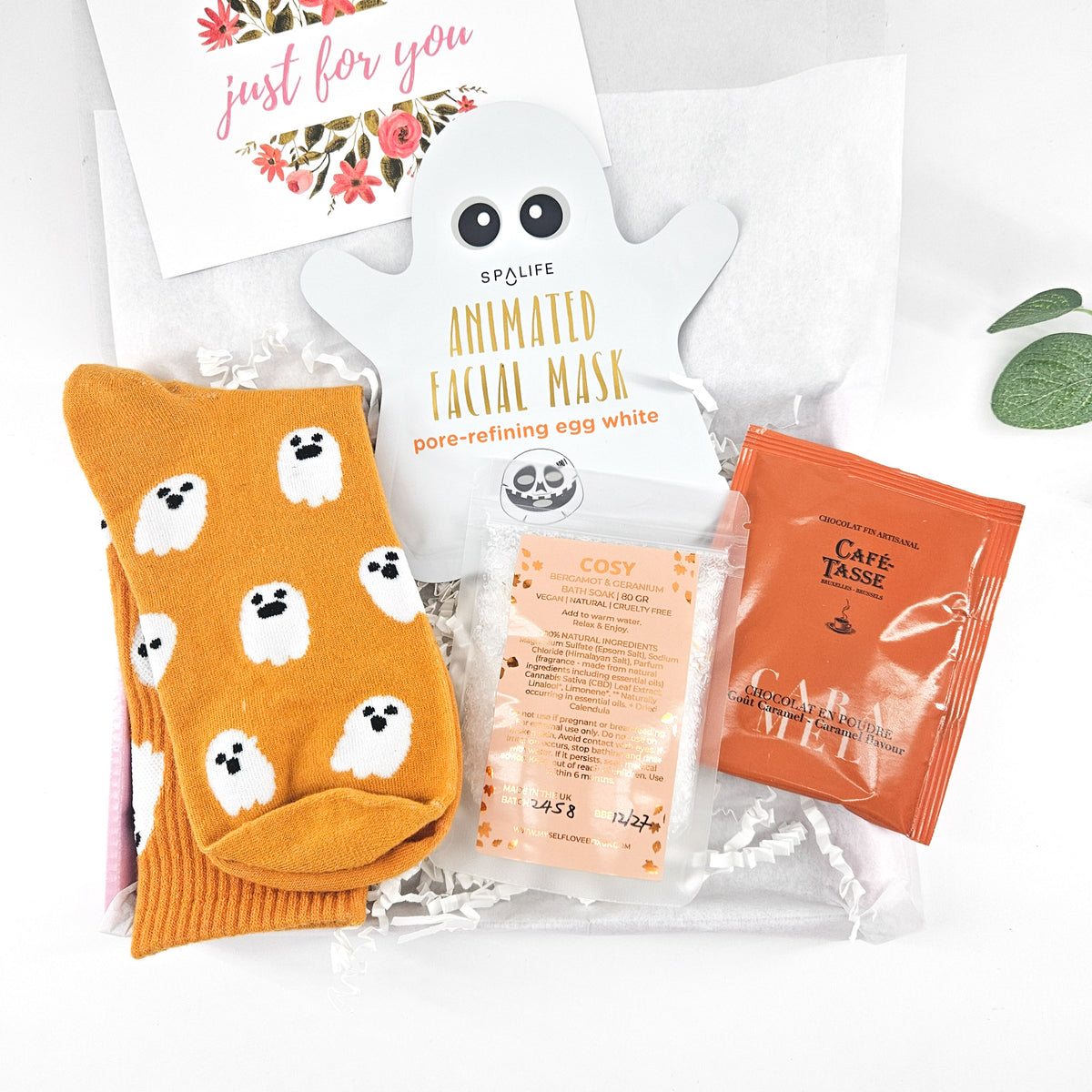The Little Boo Box Halloween letterbox gift with orange ghost socks, SpaLife ghost facial mask, COSY bath soak and Café-Tasse chocolate drink